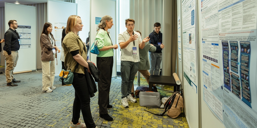 Luca Bennardo explaining his poster at the conference.